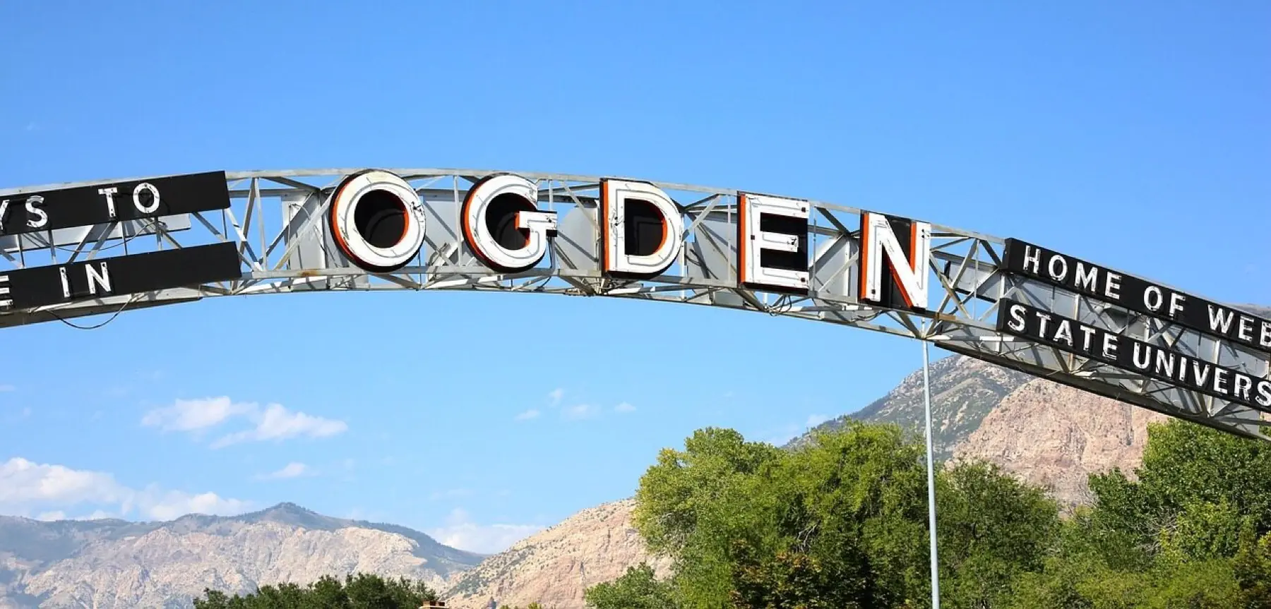 The Ogden city sign with the Wasatch Range behind it
